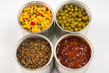 Canned food on white background. Green pea, beans, corn, lentils.