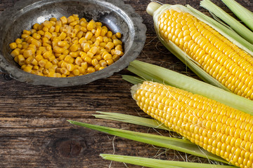 Corns on the wooden rustic table with their cobs