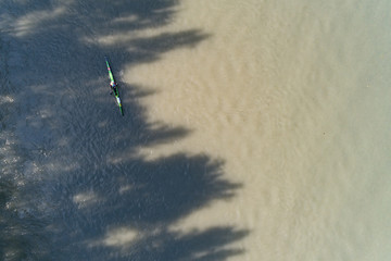  Top view of canoe rowing down, Aerial view of athlete floating on kayaks in the river