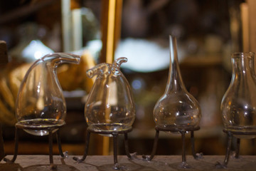 Fototapeta na wymiar Set of alchemy bottles in laboratory of alchemist. Herb in old pots with dust on the glass surface.Alchemy symbol and objects. Poison and elixir in glass jar. Set of vessel, ampulla, flask,drink.....