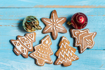 Colorful fir, spruce toy cookies on a blue wooden background close up. The concept of preparing for the holidays New Year and Christmas