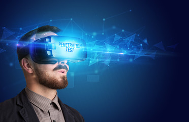 Businessman looking through Virtual Reality glasses with PENETRATION TEST inscription, cyber security concept