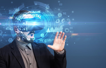 Fototapeta premium Businessman looking through Virtual Reality glasses with DIGITAL inscription, innovative technology concept