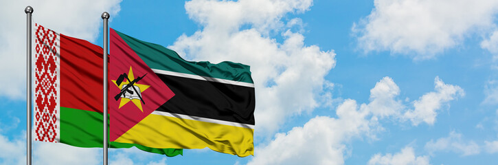 Belarus and Mozambique flag waving in the wind against white cloudy blue sky together. Diplomacy concept, international relations.
