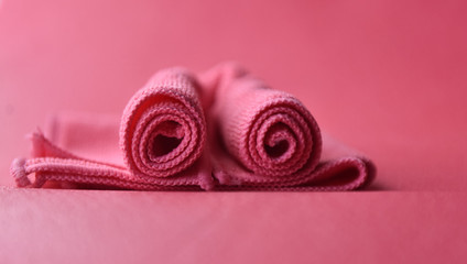 pink towels in a fold on a pink background