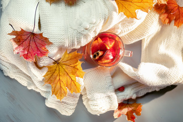 Hot grog, warm sweater and autumn leaves
