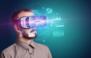 Businessman looking through Virtual Reality glasses with CAPEX inscription, new business concept