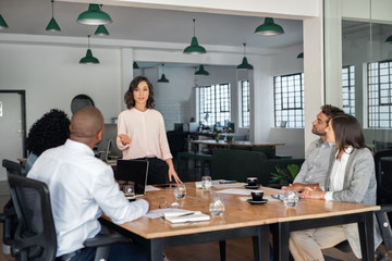 Businesswoman meeting with her diverse team in an office