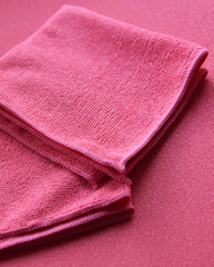 Fototapeta na wymiar pink towels in a fold on a pink background