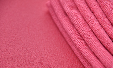 pink towels in a fold on a pink background