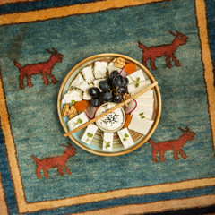 cheese plate with goat, white cheese, grapes, walnut and dried apricot