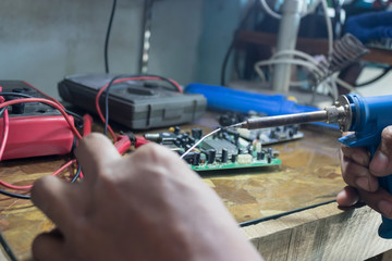 Technicians use a soldering iron and lead to repair electronic circuits.