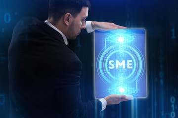 The concept of business, technology, the Internet and the network. A young entrepreneur working on a virtual screen of the future and sees the inscription: SME