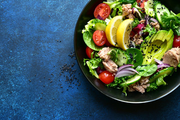 Vegetable salad with tuna and avocado. Top view with copy space.