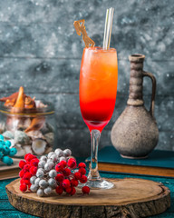 citrus ombre cocktail drink with ice cubes in champagne glass