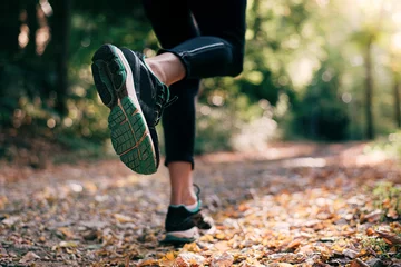 Foto op Plexiglas Female person running in the nature in autumn © eshana_blue