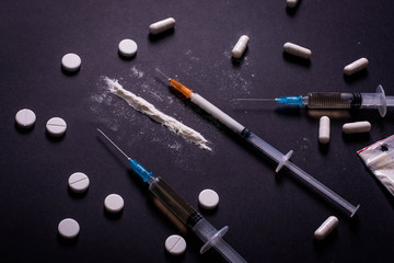 Hard drugs on dark table. concept of crime and addiction. Drug heroin, syringes