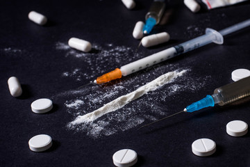 Hard drugs on dark table. concept of crime and addiction. Drug heroin, syringes