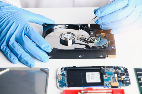 The abstract image of the technician repairing inside of hard disk drive by screwdriver in the lab. the concept of data, hardware, technician and technology