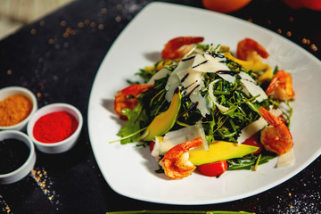 fried shrimp salad with arugula, avocado, parmesan, tomato