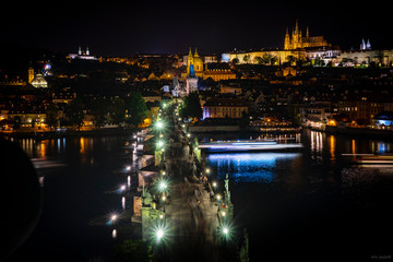 Fototapeta na wymiar Beautiful low angle view of Charles Bridge from Old Town Bridge Tower at night. Long exposure. Holidays in Prague