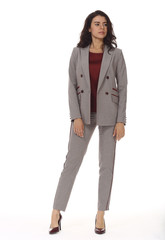 indian business woman executive posing in checkered gray formal official pantsuit high heels stiletto shoes