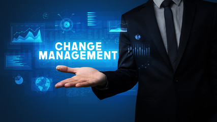Hand of Businessman holding CHANGE MANAGEMENT inscription, business success concept