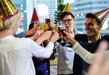 Business men and women with glasses of champagne and wine celebrating Christmas and New Year for success in Business at the Office/Anniversary