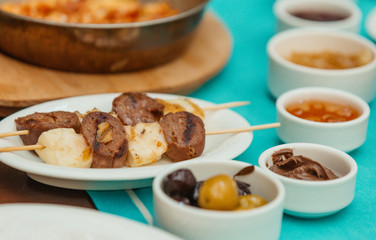 grilled beef sausages on wood skewers served for traditional breakfast