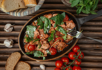 grilled chicken pieces garnished with coriander, dill, basil, and ketchup