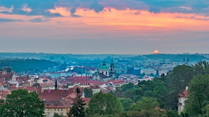 A beautiful spring view of Prague at sunrise from Petrin hill. Pink rising sun in the background. Holidays in Prague