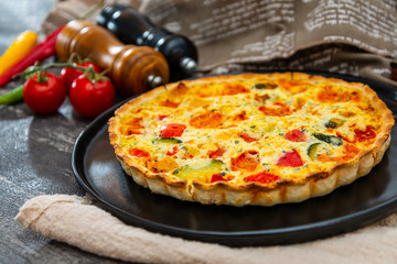 vegetable pie with cherry tomatoes, grilled peppers and courgettes with fresh eggs and fresh cream