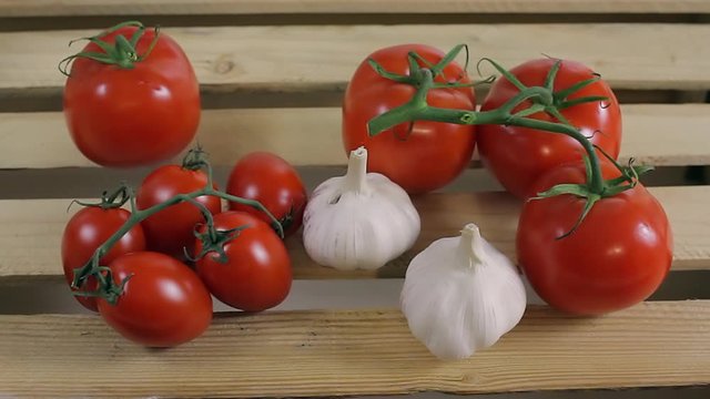 Tomatoes and garlic on a wooden box of vegetables_3