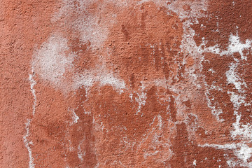 Fototapeta premium Texture of old cement plaster painted red. Weathered painted wall background texture