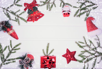 christmas decoration and red gift box on white wooden background