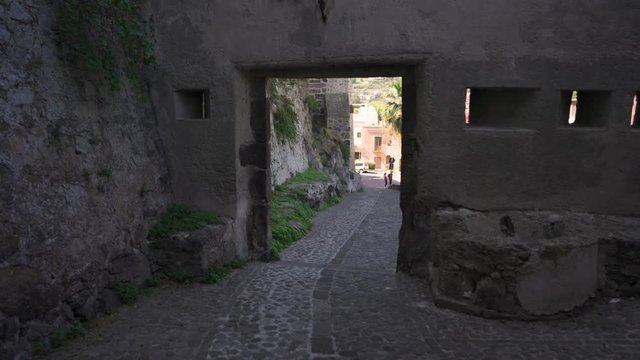 Walking through the gates of the citadel in Lipari town, Italy
