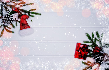 christmas decoration and red gift boxes on white wooden background