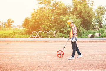 Construction using distance measure wheel on the road