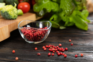 Red peas in a glass bowl and vegetables near a cutting board