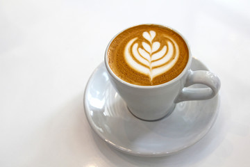 Top view of coffe in a white cup.