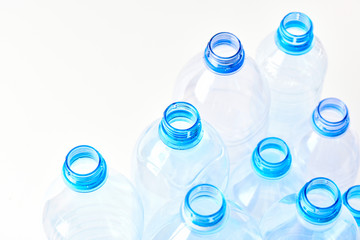 Set bottles of mineral water different types and sizes stand isolated on white background. Plastic production and processing concept