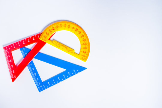 Concept image of colourful rulers and protractor in white background.