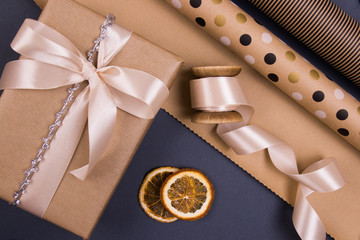 Background for Christmas. Holidays gift box in a kraft paper cover, dry orange, design holidays...