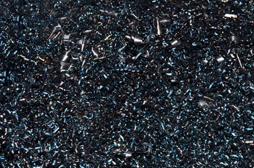 Steel scrap materials recycling. Abstract, background and texture of metal shavings. Aluminum chip waste after machining metal parts on a cnc lathe