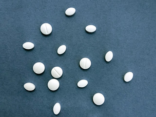 photo white pills on a blue background