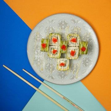 sushi rolls with shrimp covered with avocado and red tabiko