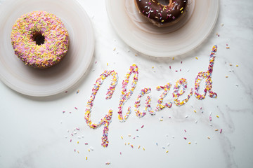 Obraz na płótnie Canvas Dessert Donuts on Plates with Sprinkles