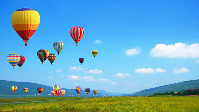 Fototapeta Hot Air balloons flying over mountain landscape background.