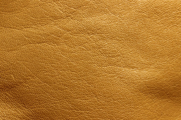 Blurred leather background, ocher color. Abstract texture background out of focus. Abstract light-brown background.