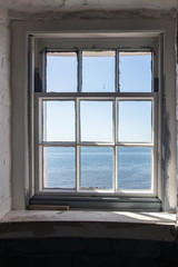 window looking out to sea at Point Prim Light House Museum in PEI